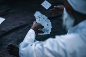 Old man playing cards.