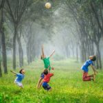 Kids playing in a field.