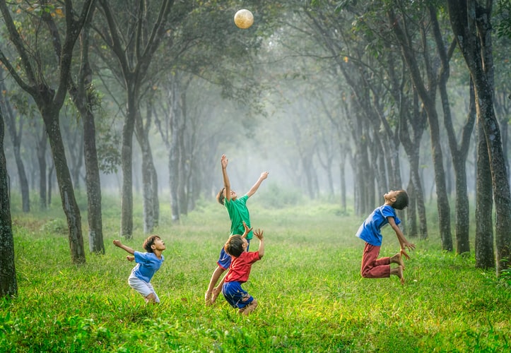 Kids playing in a field.