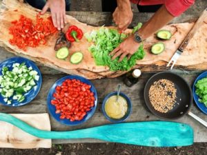 People cutting vegetables together