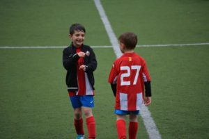 Two boys in soccer field